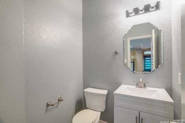 6763 Indian Ldg, San Antonio, TX 78253 - half bathroom featuring a textured wall, toilet, and vanity