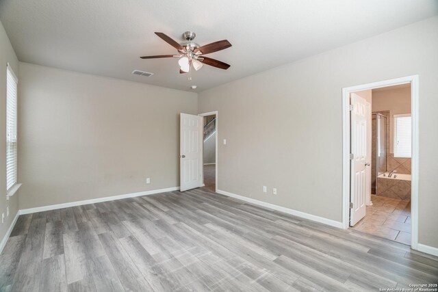 6763 Indian Ldg, San Antonio, TX 78253 - unfurnished bedroom featuring light wood-type flooring, baseboards, connected bathroom, and ceiling fan