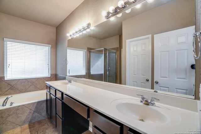 6763 Indian Ldg, San Antonio, TX 78253 - full bath with double vanity, a stall shower, a garden tub, and tile patterned floors