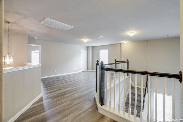 6763 Indian Ldg, San Antonio, TX 78253 - hall featuring an upstairs landing, wood finished floors, baseboards, and a textured ceiling