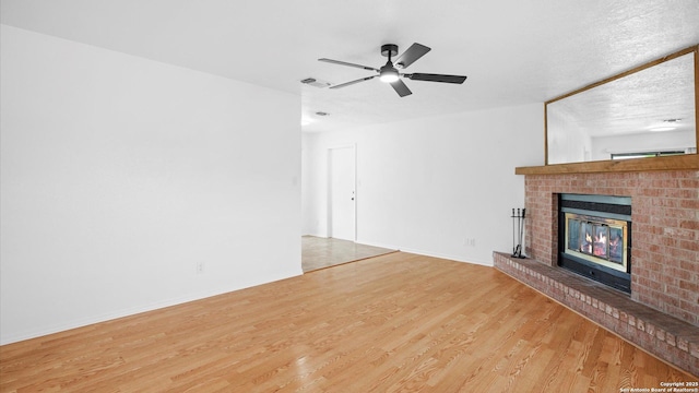 218 Gruene, New Braunfels, TX 78130 - unfurnished living room with a fireplace, wood finished floors, and ceiling fan