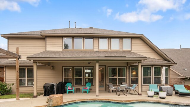 32337 Lavender Cv, Bulverde, TX 78163 - back of property with a patio area, an outdoor pool, and a shingled roof