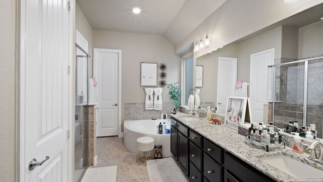 32337 Lavender Cv, Bulverde, TX 78163 - bathroom with double vanity, a stall shower, a bath, tile patterned floors, and tile walls