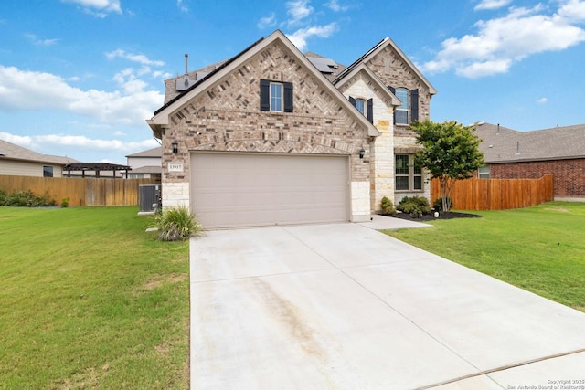 13917 Westbury Fls, San Antonio, TX 78253 - view of front of house with stone siding, driveway, roof mounted solar panels, and central AC unit