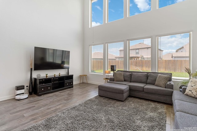13917 Westbury Fls, San Antonio, TX 78253 - living area with wood finished floors, baseboards, and a high ceiling