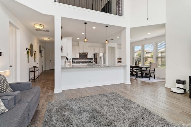 13917 Westbury Fls, San Antonio, TX 78253 - living area featuring wood tiled floors, recessed lighting, and baseboards