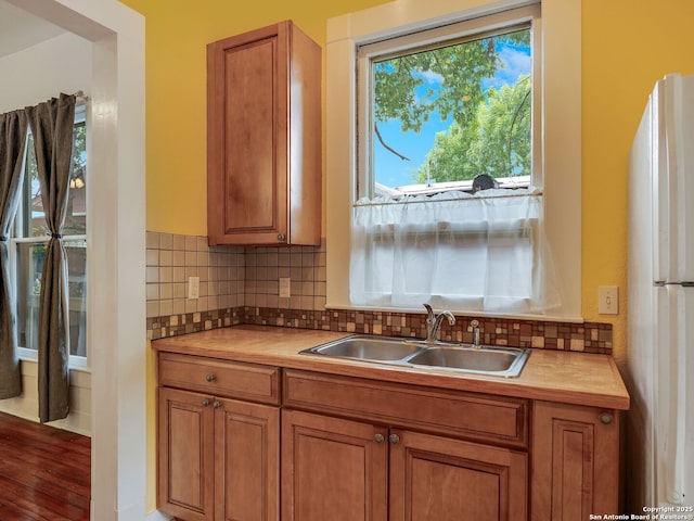 1211 W Magnolia Ave, San Antonio, TX 78201 - kitchen with a sink, freestanding refrigerator, brown cabinetry, and light countertops