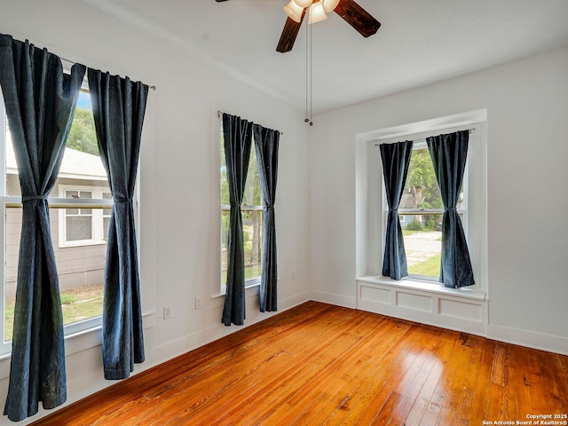 1211 W Magnolia Ave, San Antonio, TX 78201 - unfurnished room featuring healthy amount of natural light, light wood-style floors, ceiling fan, and baseboards