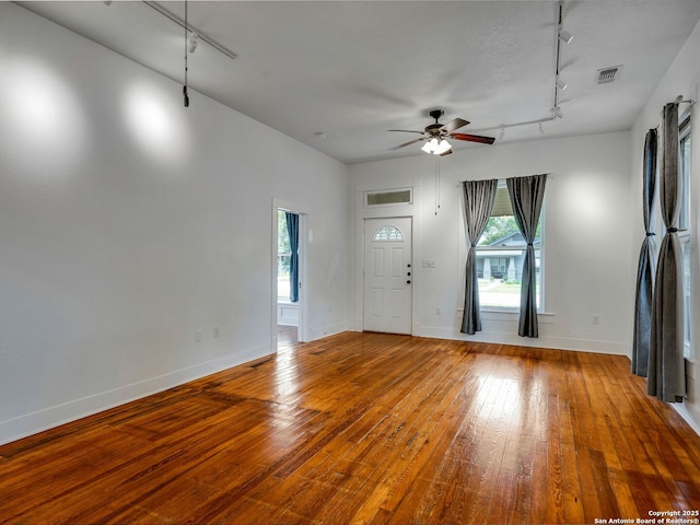 1211 W Magnolia Ave, San Antonio, TX 78201 - entrance foyer with rail lighting, ceiling fan, and hardwood / wood-style flooring