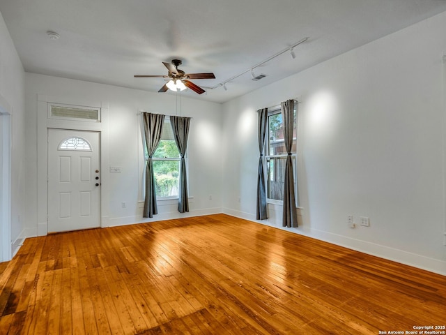 1211 W Magnolia Ave, San Antonio, TX 78201 - foyer entrance with a ceiling fan, rail lighting, wood-type flooring, and healthy amount of natural light