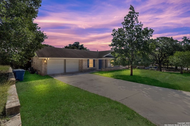 4911 Belle Ellen, San Antonio, TX 78229 - single story home with an attached garage, concrete driveway, brick siding, and a lawn