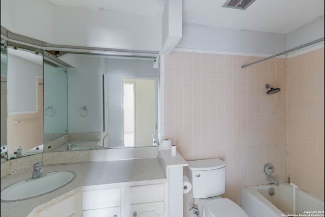 4911 Belle Ellen, San Antonio, TX 78229 - full bathroom featuring toilet, bathtub / shower combination, vanity, and tile walls
