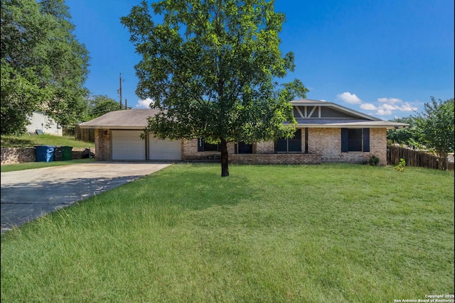 4911 Belle Ellen, San Antonio, TX 78229 - view of front facade with concrete driveway, an attached garage, and brick siding