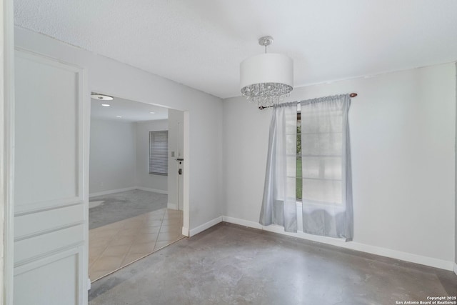 4911 Belle Ellen, San Antonio, TX 78229 - unfurnished room featuring concrete flooring, baseboards, and a chandelier