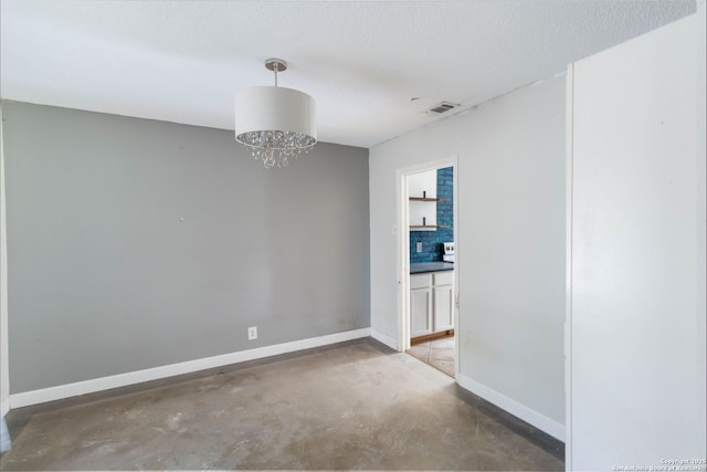 4911 Belle Ellen, San Antonio, TX 78229 - unfurnished room featuring concrete floors, baseboards, a chandelier, and a textured ceiling