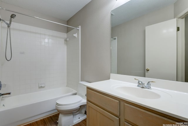 5711 Timberhurst, San Antonio, TX 78250 - full bath with wood finished floors, vanity, shower / bath combination, and a textured ceiling