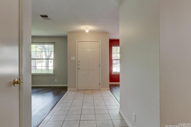 5711 Timberhurst, San Antonio, TX 78250 - foyer with baseboards and light tile patterned floors
