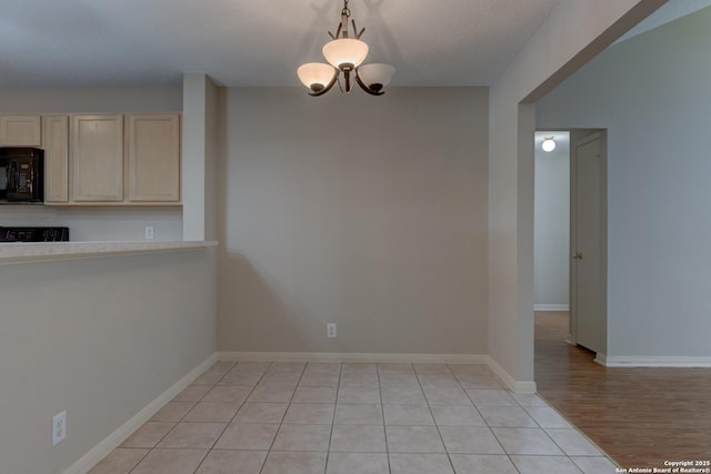 5711 Timberhurst, San Antonio, TX 78250 - unfurnished dining area featuring baseboards and light tile patterned flooring