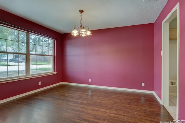 5711 Timberhurst, San Antonio, TX 78250 - empty room featuring a chandelier, wood finished floors, and a textured ceiling