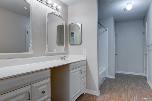 5711 Timberhurst, San Antonio, TX 78250 - bathroom featuring vanity, wood finished floors, and bathing tub / shower combination