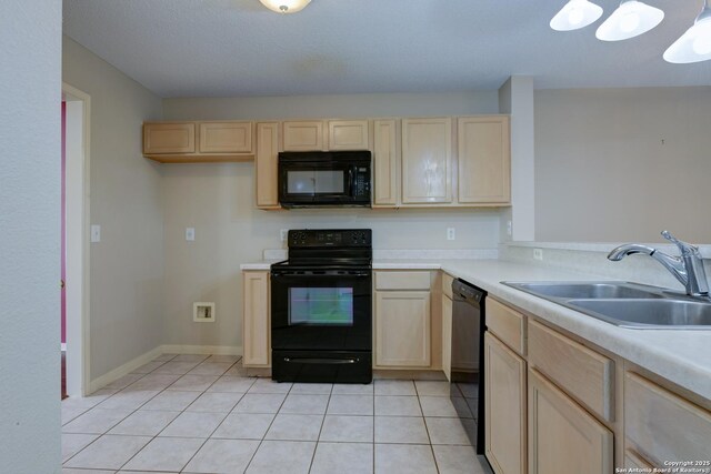 5711 Timberhurst, San Antonio, TX 78250 - kitchen with black appliances, light brown cabinets, and light tile patterned floors