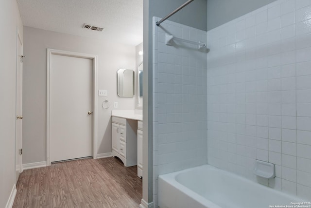 5711 Timberhurst, San Antonio, TX 78250 - full bathroom with vanity, wood finished floors, and shower / bathtub combination