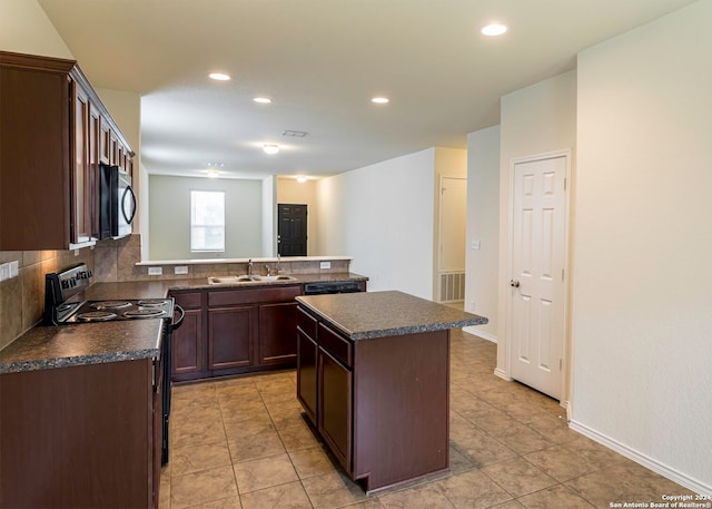468 Salz Way, San Antonio, TX 78260 - kitchen featuring dark countertops, black appliances, dark brown cabinetry, recessed lighting, and a kitchen island