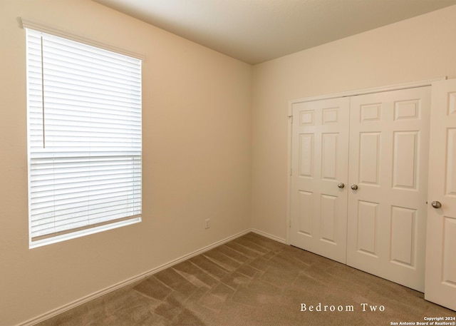 468 Salz Way, San Antonio, TX 78260 - unfurnished bedroom featuring carpet flooring, a closet, and multiple windows