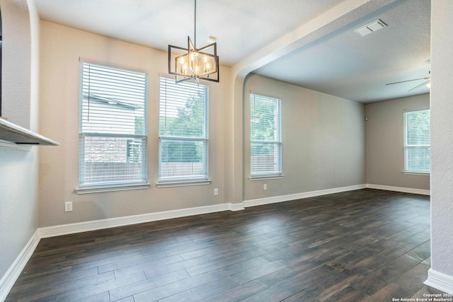 7030 Plains Way, San Antonio, TX 78253 - empty room featuring dark wood-style floors, a chandelier, arched walkways, and baseboards