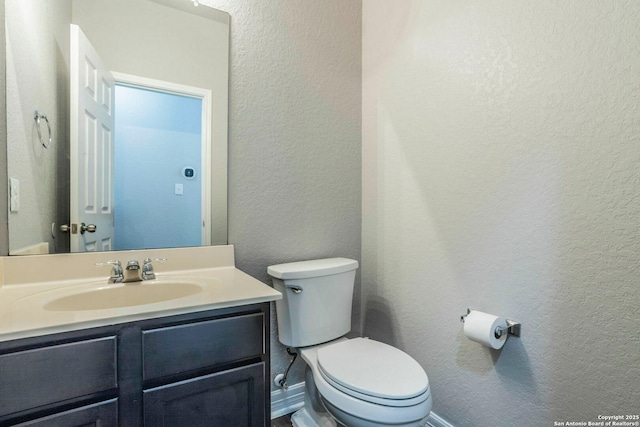 7030 Plains Way, San Antonio, TX 78253 - bathroom featuring toilet, a textured wall, vanity, and baseboards