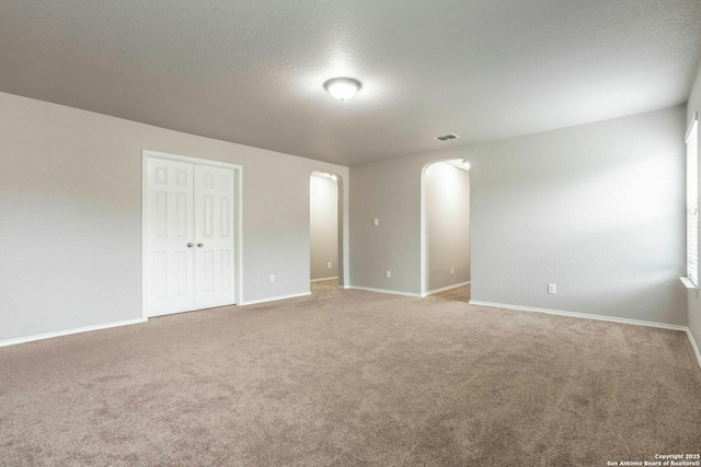 7030 Plains Way, San Antonio, TX 78253 - empty room with arched walkways, carpet, baseboards, and a textured ceiling