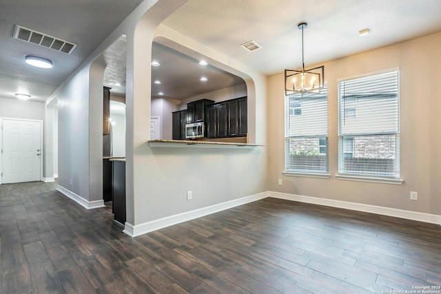 7030 Plains Way, San Antonio, TX 78253 - kitchen featuring stainless steel microwave, dark wood finished floors, a chandelier, and baseboards