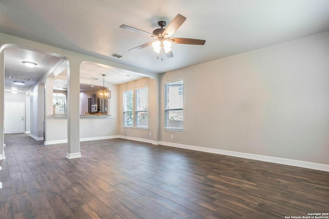 7030 Plains Way, San Antonio, TX 78253 - unfurnished living room featuring arched walkways, dark wood finished floors, baseboards, and ceiling fan