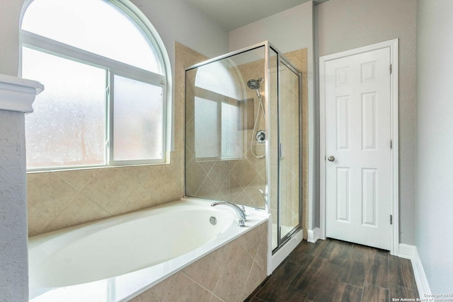 7030 Plains Way, San Antonio, TX 78253 - bathroom with a bath, a stall shower, wood finished floors, and baseboards