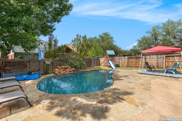 815 Maltese Gdn, San Antonio, TX 78260 - view of swimming pool with a patio area, a fenced backyard, and a playground