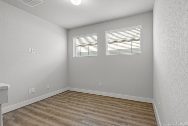 8851 Oakland Rd, San Antonio, TX 78240 - spare room featuring healthy amount of natural light, wood finished floors, and baseboards