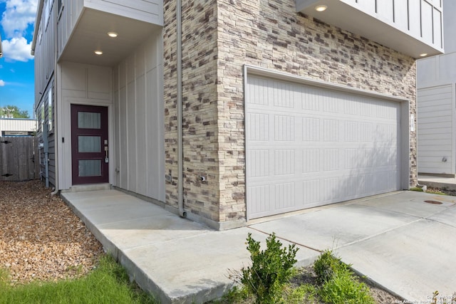 8851 Oakland Rd, San Antonio, TX 78240 - property entrance featuring driveway, board and batten siding, and a garage