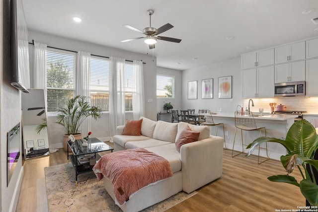 8851 Oakland Rd, San Antonio, TX 78240 - living area featuring light wood finished floors, ceiling fan, and recessed lighting