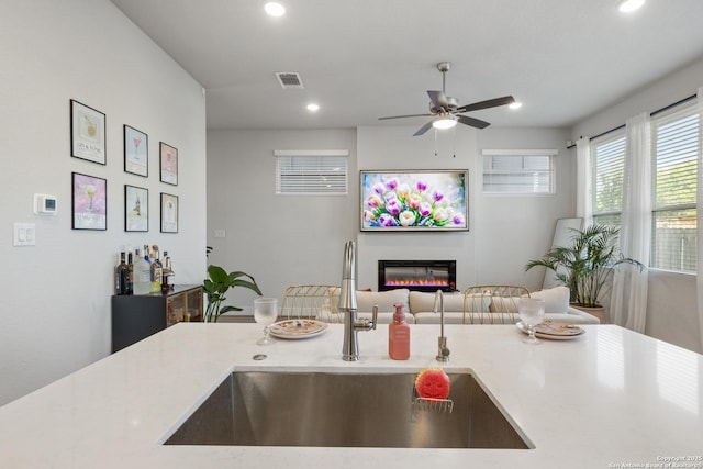 8851 Oakland Rd, San Antonio, TX 78240 - kitchen with a sink, ceiling fan, a glass covered fireplace, open floor plan, and recessed lighting