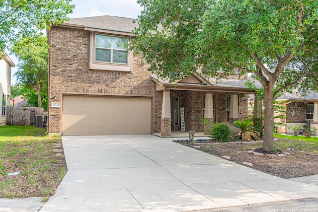10736 Gemsbuck Ldg, San Antonio, TX 78245 - view of front of property featuring central AC unit, an attached garage, brick siding, and concrete driveway