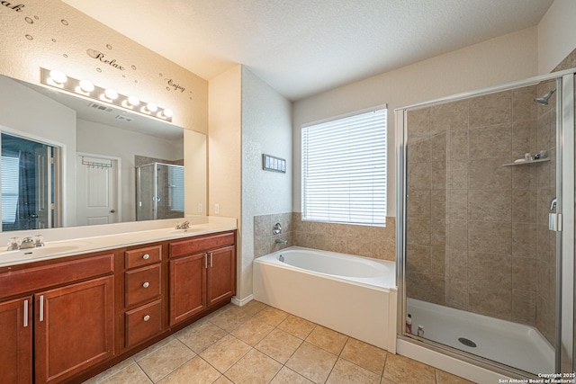 10736 Gemsbuck Ldg, San Antonio, TX 78245 - bathroom with a stall shower, double vanity, a garden tub, and tile patterned floors