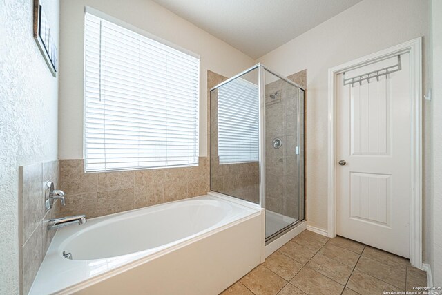 10736 Gemsbuck Ldg, San Antonio, TX 78245 - bathroom with a bath, a stall shower, and tile patterned flooring