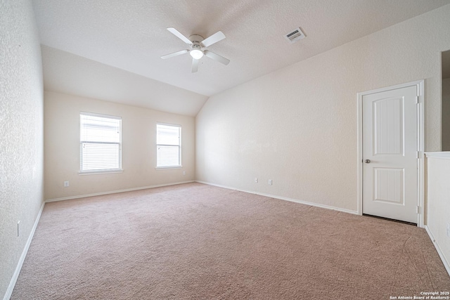 10736 Gemsbuck Ldg, San Antonio, TX 78245 - carpeted spare room with a ceiling fan, lofted ceiling, baseboards, and a textured ceiling