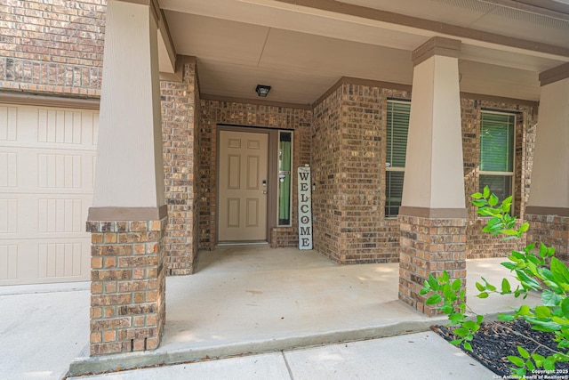 10736 Gemsbuck Ldg, San Antonio, TX 78245 - doorway to property featuring brick siding and covered porch