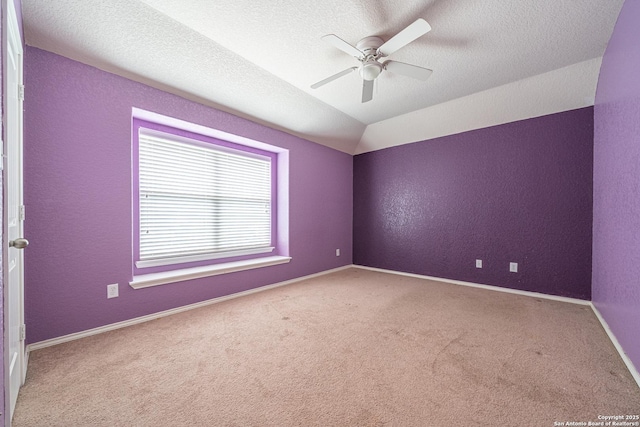 10736 Gemsbuck Ldg, San Antonio, TX 78245 - spare room with carpet flooring, ceiling fan, a textured wall, baseboards, and vaulted ceiling
