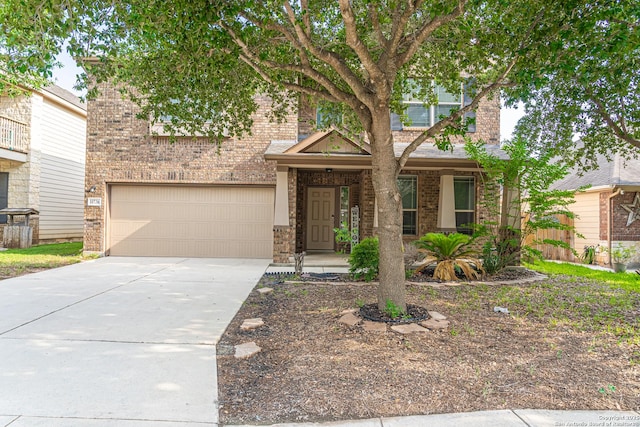10736 Gemsbuck Ldg, San Antonio, TX 78245 - view of front facade featuring a garage, concrete driveway, and brick siding