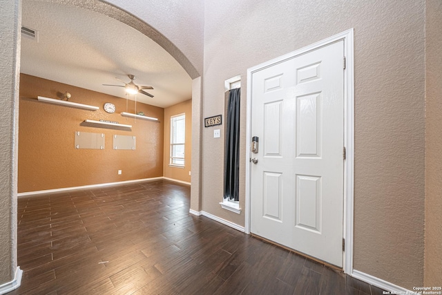 10736 Gemsbuck Ldg, San Antonio, TX 78245 - foyer with a textured wall, arched walkways, ceiling fan, wood finished floors, and a textured ceiling
