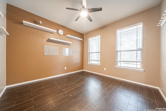 10736 Gemsbuck Ldg, San Antonio, TX 78245 - unfurnished room featuring a textured wall, a ceiling fan, baseboards, and dark wood-type flooring