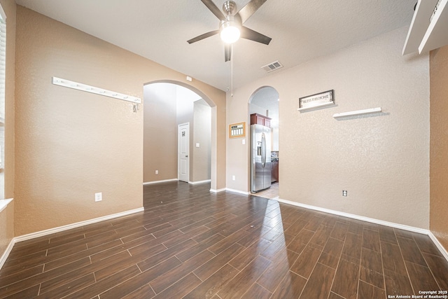10736 Gemsbuck Ldg, San Antonio, TX 78245 - empty room with ceiling fan, dark wood-type flooring, arched walkways, and baseboards