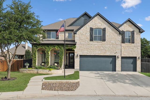 25723 Coreopsis, San Antonio, TX 78261 - view of front of property featuring stone siding, an attached garage, concrete driveway, and roof with shingles